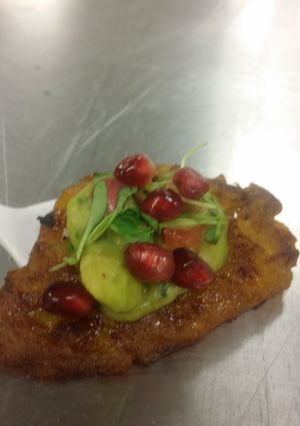 A picture of Tapas -- Plantain with a pomegranate guacamole.