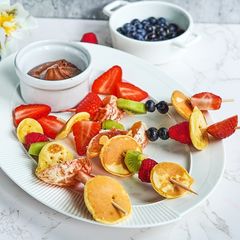A picture of Pancake fruit skewers.