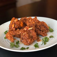 A picture of Crunchy Fried Chicken with Sweet and Spicy Drizzle.