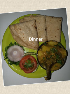 A picture of Potato brinjal bhaji chapati and onion tomato salad.