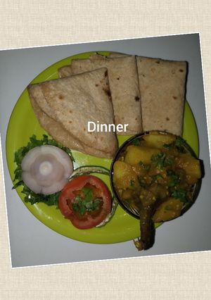 A picture of Potato brinjal bhaji chapati and onion tomato salad.