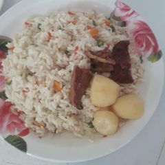 A picture of Coconut rice with sauced irish potatoes.