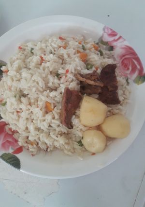 A picture of Coconut rice with sauced irish potatoes.