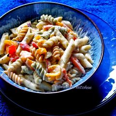 A picture of Colorful white sauce pasta.