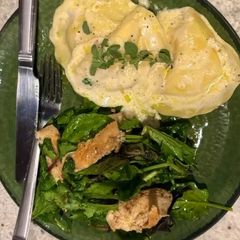 A picture of Lobster Ravioli with Cream Butter Sauce and Lemon Pepper Grilled Chicken.
