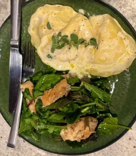 A picture of Lobster Ravioli with Cream Butter Sauce and Lemon Pepper Grilled Chicken.