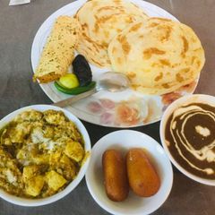 A picture of Dal Makhani,paneer -butter masala,tandoori parathas.