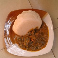 A picture of Groundnut soup and cassava swallow.