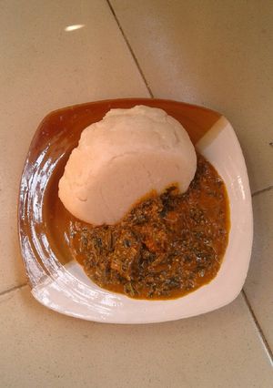 A picture of Groundnut soup and cassava swallow.