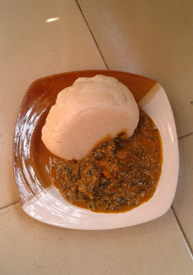 A picture of Groundnut soup and cassava swallow.