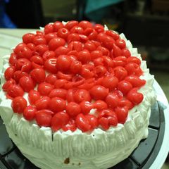 A picture of Layered upside down apple caramel cinnamon cake with whipped cream and cherries.