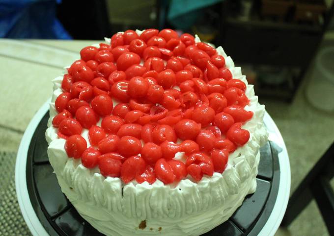 Layered upside down apple caramel cinnamon cake with whipped cream and cherries