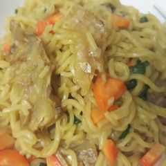 A picture of Indomine with stockfish and vegetables.