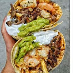 A picture of Monster steak and shrimp burritos.