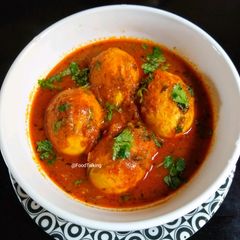A picture of Egg Curry With Curd.