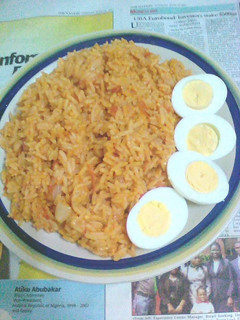 A picture of Jollof rice with boiled eggs.