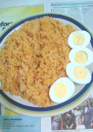 A picture of Jollof rice with boiled eggs.