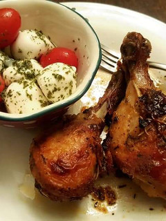 A picture of Mozzarella cheese with tomato Caprese salad and roasted chicken.