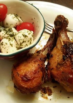 A picture of Mozzarella cheese with tomato Caprese salad and roasted chicken.