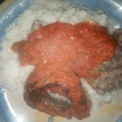 Rice and beans with panla fish and sauce A picture of Rice and beans with panla fish and sauce.