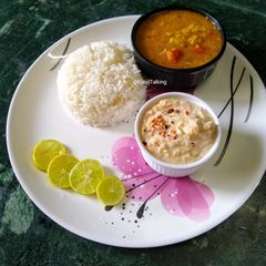 A picture of Green Papaya, Moong Dal Curry (no onion, garlic) with Raita and.