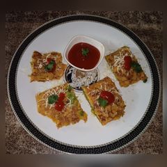 A picture of Stuffed cheesy besan cheela pockets.