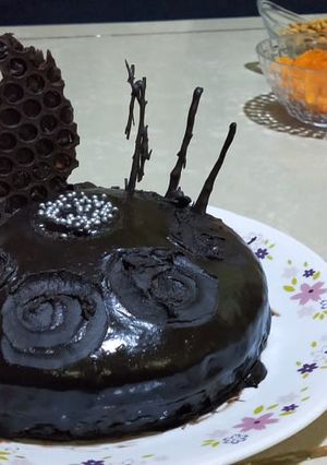 A picture of Dark Chocolate cake with homemade sauce.