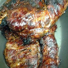 A picture of Pork brisket on the grill with semi- dry rub.