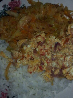 A picture of Rice served with scrambled eggs and steamed vegetables.
