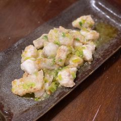 A picture of Monkfish meunière with leek green and lemon juice.
