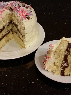 A picture of Vanilla Layer Cake with Whipped Chocolate Ganache Filling and Whipped Coconut Cream Frosting.