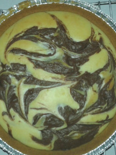 A picture of Vanilla-Chocolate Swirl Hazelnut Cheesecake.