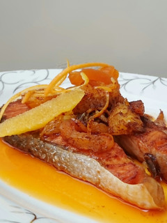 A picture of Salmon With Orange And Dried Apricot In Spicy Butter Sauce.