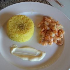 A picture of Turmeric rice with pan fried butter garlic shrimp and mayo.