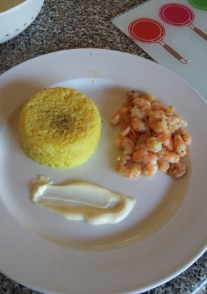A picture of Turmeric rice with pan fried butter garlic shrimp and mayo.
