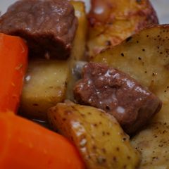 A picture of Stew Beef & Gravy w/Herb Roasted Potatoes.