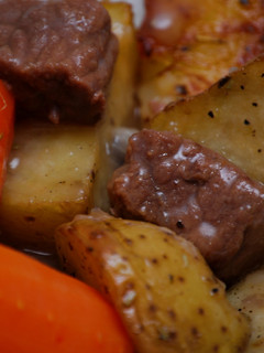 A picture of Stew Beef & Gravy w/Herb Roasted Potatoes.