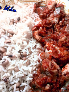 A picture of Rice and beans with stew.