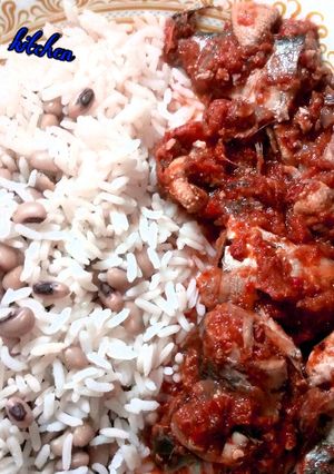 A picture of Rice and beans with stew.