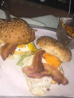 A picture of Fancy chicken egg and bacon burgers.