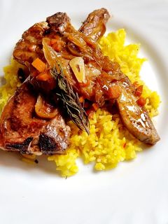 Una foto de Cordero con miel y romero sobre arroz al azafrán