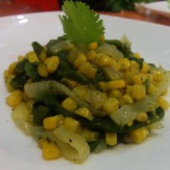 A picture of Corn and rajas (pepper strips).