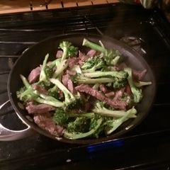 A picture of Beef and broccoli with hazelnuts.