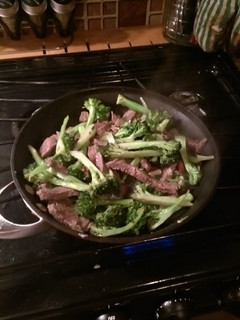A picture of Beef and broccoli with hazelnuts.