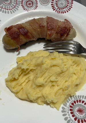 Une photo de Boudin blanc à la truffe enveloppé d’une fine tranche de lard