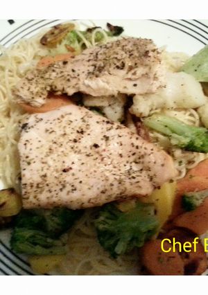 A picture of Baked fish with vegetable pasta.