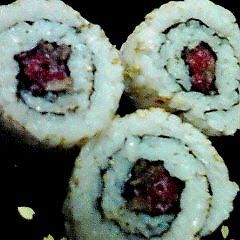 A picture of Sushi Rolls with Lightly Seared Beef.