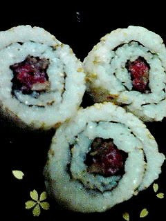 A picture of Sushi Rolls with Lightly Seared Beef.