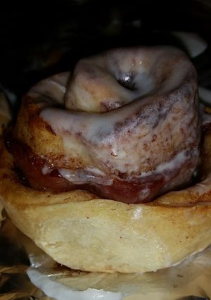 A picture of Cinnamon Rolls with bacon rolled in them.