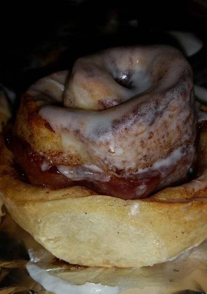 A picture of Cinnamon Rolls with bacon rolled in them.